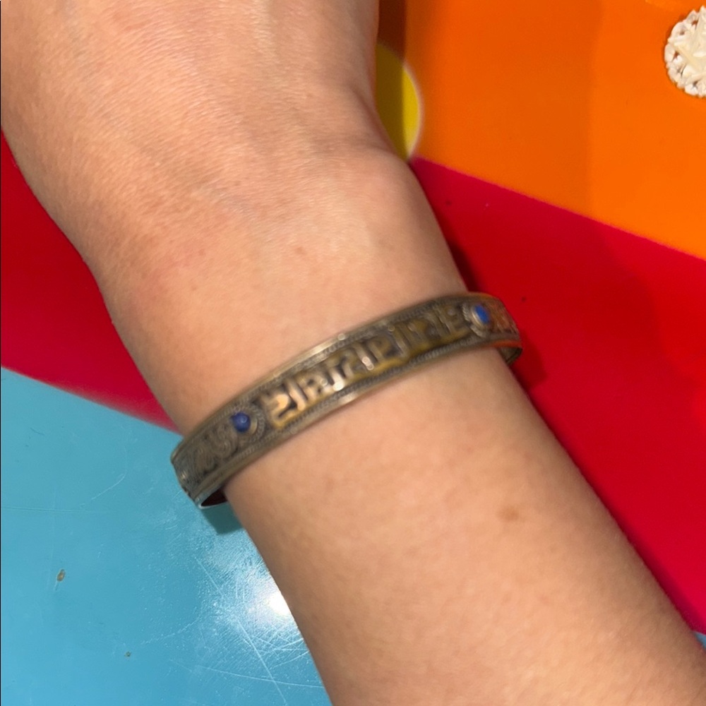 Antique-looking silver (?) bracelet with possible Buddhist chant